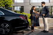 © rh2010 - Female chauffeur gives a businessman his suit, after a business trip in luxury taxi. Concept of personal assistant, driver and business transportation service