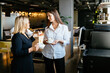 Two mature businesswomen having coffee break at office. Creative business people having informal meeting in office kitchen