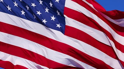 Wall Mural - close up of the us flag blowing in the breeze.