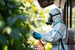 A pest control specialist in protective gear is spraying pesticides