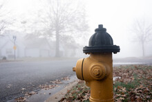 Close-up Of Fire Hydrant Next To Residential Road Surrounded By Fog