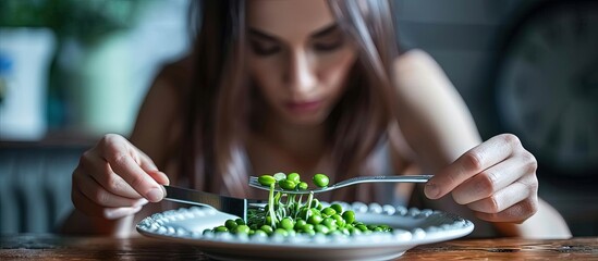 Aufkleber - Diet or Anorexic in Health Care Concept Eating Disorder Lose Weight Young Woman Using Fork and Knife to Eating Green Soy Bean on Plate Unhappy Food Top View. Creative Banner. Copyspace image