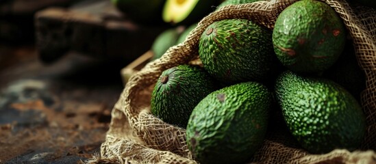 Poster - Avocados on grocery produce store shop supermarket display raw unripe tropical green fruit in mesh net bags. Creative Banner. Copyspace image