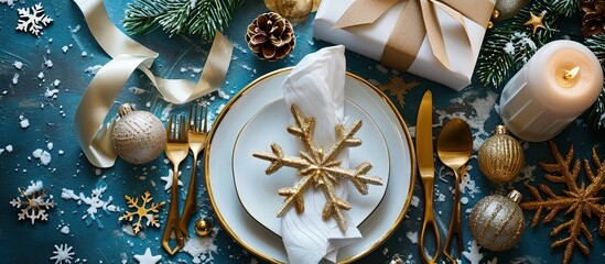 Poster - Christmas festive table setting with white plates and gold cutlery white linen napkin gifts in white and gold paper wooden snowflake decoration paper decorations and balls Flatlay blue and gold