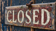 Wooden closed sign on an old wooden door, closeup.