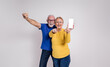 © Moon Safari - Ecstatic senior couple screaming and showing blank screen of smart phone against white background