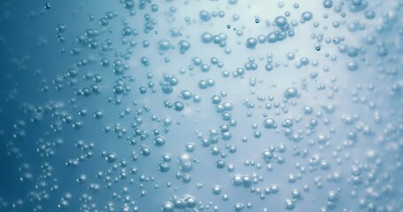 Wall Mural - Many water bubbles in blue water close up, abstract water wave with bubbles in slow motion.