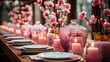 Elegant dinner table setting with pink candles, cherry blossoms, and fine glassware, perfect for romantic and festive occasions.