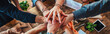 a group of business people holding their hands above each other, team building