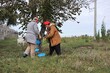 © Владимир Коврижник - A middle-aged girl and woman harvest nuts in the garden in autumn