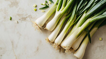 Fresh spring onions on a light background, top view, copy space