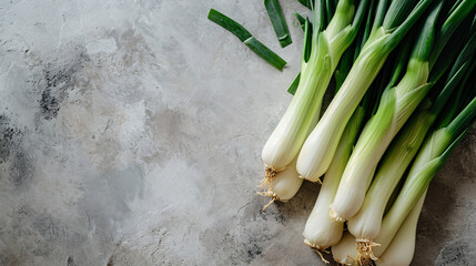 Wall Mural - Fresh green spring onions on gray background, top view, copy space