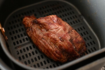 Wall Mural - baked beef meat in aero grill bowl, baked healthy steak in multicooker bowl 