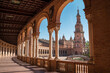 The Plaza de España galleries lited up with evening sunlight making magic shadows. North tower view on Spain Square, Andalusia, South Spain.