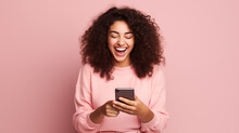Very Happy Woman With Long Hair Checking Her Phone And Smiling On A Pink Clean Background	
