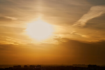 Wall Mural - Evening sun in the sunset sky in the light of rays from behind the clouds