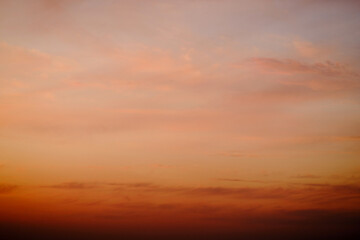 Wall Mural - Evening clouds in the sunset sky in the light of the rays of the setting sun