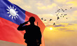 Silhouette of a soldier with the Taiwan flag stands against the background of a sunset or sunrise. Concept of national holidays. Commemoration Day.