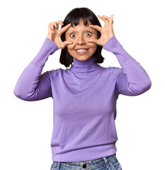 Young Hispanic woman with short black hair in studio keeping eyes opened to find a success opportunity.