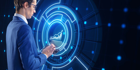 Poster - Side view of young european businessman using tablet with glowing business chart hologram on blurry background. Financial plan graph.