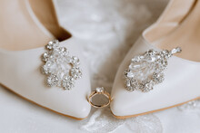 Details Of The Bride. Beauty Is In The Details. High-heeled Bridal Shoes. Gold Wedding Ring With A Diamond. Perfumes. Earrings Wedding In Details.