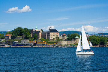 Wall Mural - Sailboat in Oslofjord, Akershus Castle and Fortress in the background, Oslo, Norway