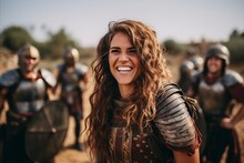 Portrait Of Smiling Girl In Medieval Armor With Friends On Background.