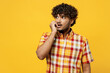 Young minded pensive confused puzzled Indian man wears shirt casual clothes biting nails fingers look aside on area mock up isolated on plain yellow color background studio portrait Lifestyle concept