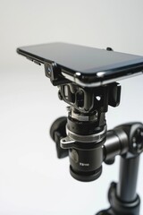 Leinwandbilder - A cell phone sitting on top of a tripod. Perfect for capturing stable and professional photos or videos. Ideal for photographers, videographers, and content creators