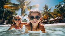 Two Happy Children In Glasses In The Pool Against The Background Of Palm Trees