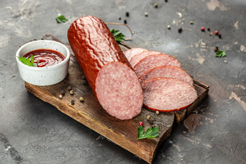 Wall Mural - Delicious sausages with ketchup sauce on a wooden background. banner, menu, recipe place for text, top view