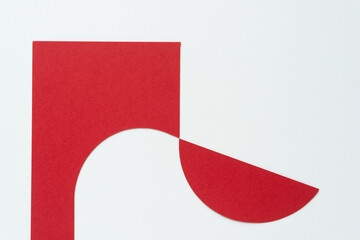 Poster - machine-cut red card stock paper shapes arranged on blank paper