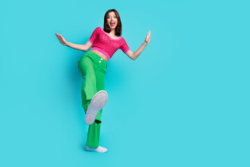 Wall Mural - full length photo of impressed woman dressed top green retro pants showing feet near empty space iso