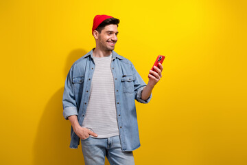 Sticker - Photo of good mood funky man dressed jeans shirt communicating modern gadget empty space isolated yellow color background