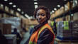 © zenzali - Black woman working in a warehouse, smiling happy to work