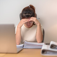 stressed Asian Woman using laptop, Tired female businesswoman working overload with headache and Sleepy at office, Exhausted casual woman with computer at late night in home. Work Life Balance concept