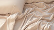 © tashechka - The soft creases of a beige silken bed sheet provide a gentle and luxurious texture in a peaceful bedroom setting.