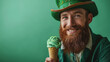 Very happy leprechaun in a traditional green Irish suit and hat with green ice cream in a cone, St Patric celebration