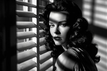 Monochrome Film Noir Portrait Of A Young Attractive Femme Fatale With Long Dark Hair Standing Next To Window Blinds