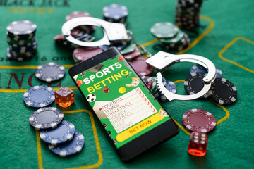 Cards cubes and chips Handcuffs close-up. Royal flush poker. Prohibited gambling concept, internet casino underground.