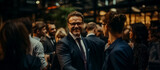 Fototapeta  - A smiling businessman in glasses and a suit at a networking event, surrounded by other professionals engaging in conversation