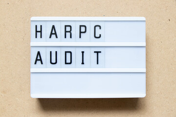 Canvas Print - Lightbox with word HARPC (Hazard analysis and risk-based preventive controls) audit on wood background