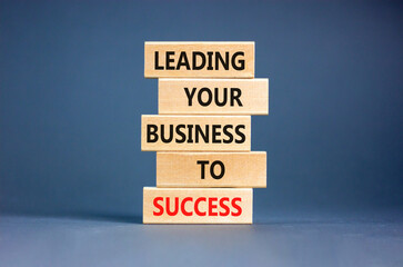 Wall Mural - Leading your business to success symbol. Concept words Leading your business to success on wooden blocks. Beautiful grey table grey background. Leading your business to success concept. Copy space.