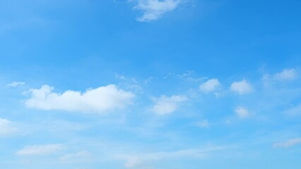 Wall Mural - Blue sky time-lapse, Witness the heavens on fast-forward as the boundless cerulean sky hosts a captivating performance, with cotton candy clouds in an ephemeral waltz. Winter sky background.
