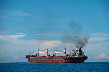 Rusty Red Cargo Ship on the Blue Ocean