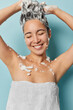 © wayhome.studio  - Vertical shot of Asian woman with eyes closed gently applies shampoo to her luscious brunette locks serene smile reflecting her pleasure immerse herself fully in blissful shower wrapped in white towel