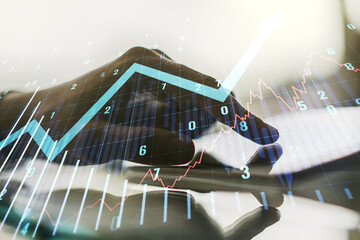 Aufkleber - Multi exposure of abstract financial graph with upward arrow and hand working with a digital tablet on background, financial and trading concept