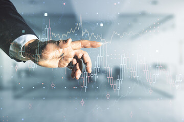 Poster - Man hand working with abstract virtual financial graph on blurred office background, forex and investment concept. Multiexposure