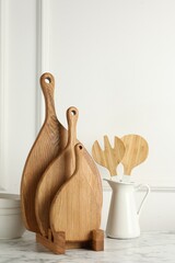 Sticker - Wooden cutting boards, kitchen utensils and dishware on white marble table