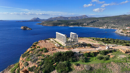 Aerial drone photo of iconic archaeological site of Cape Sounio and famous Temple of Poseidon built uphill overlooking Aegean sea, Attica, Greece